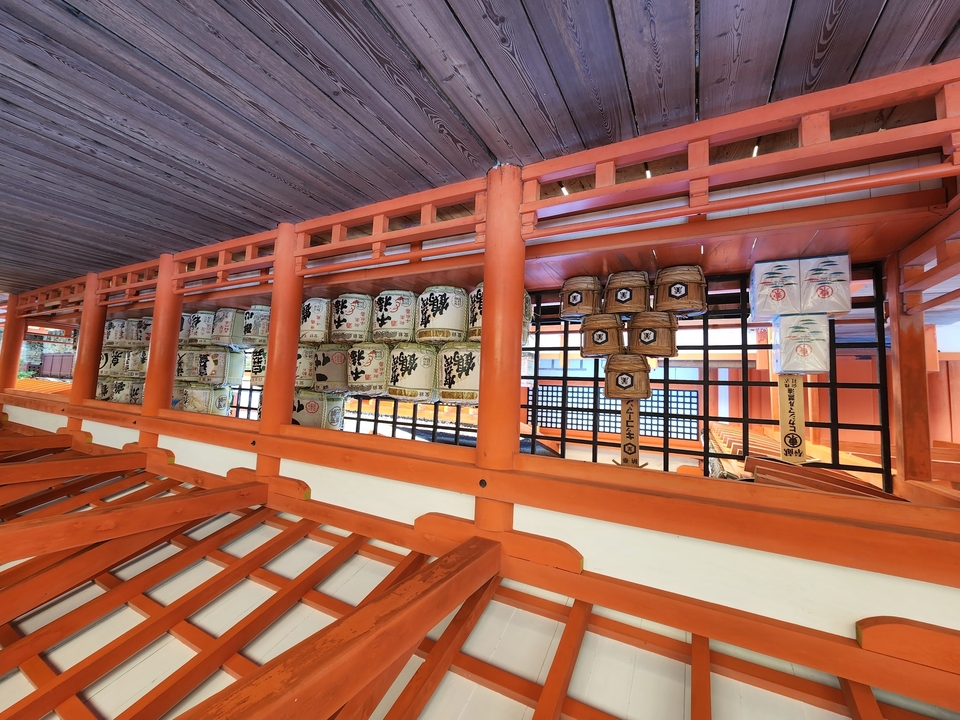 Traditional Japanese building with sake barrels on display.