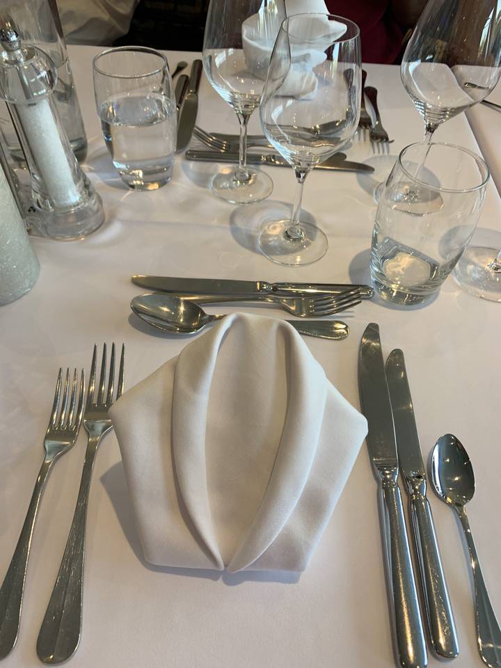 Table setting with napkins and cutlery.
