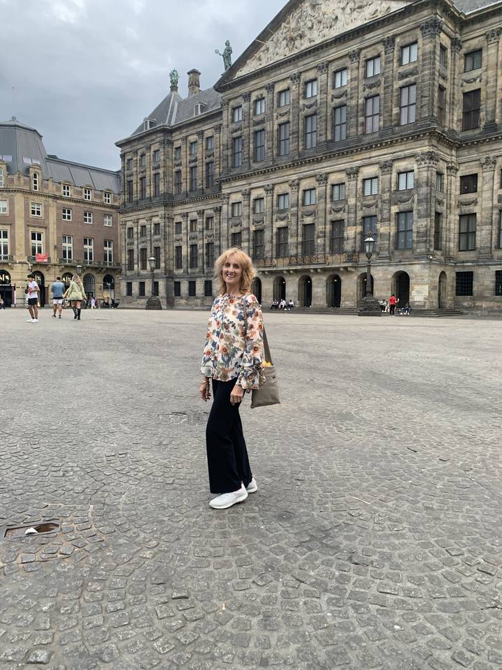 Woman standing in front of a historic building.