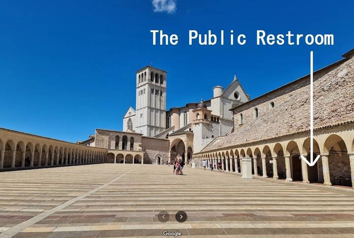 Public square with an arrow pointing to a public restroom.