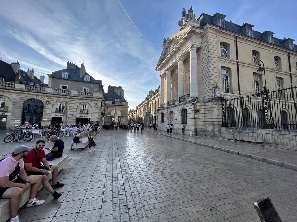A street view with people dining outdoors.