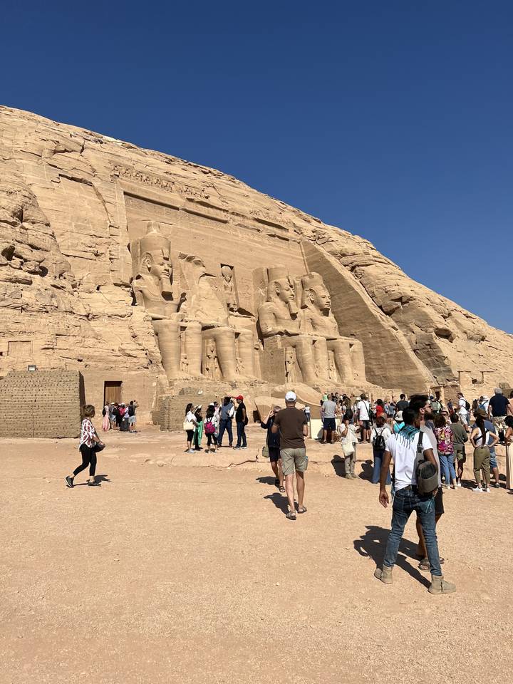 Giant statues of Ramses II with visitors at Abu Simbel, Egypt.