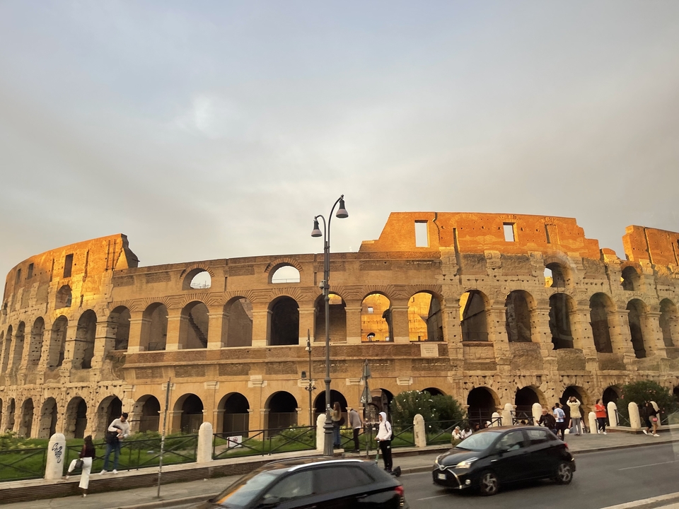 Colosseum in Rome lit by warm sunlight.