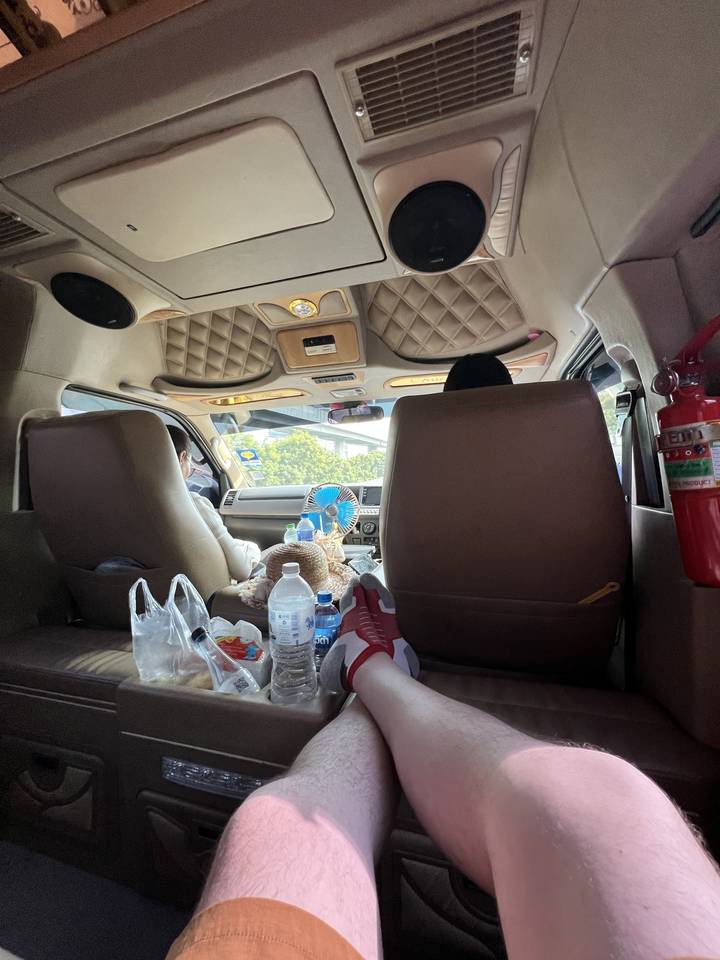 Person relaxing in a comfortable car interior.