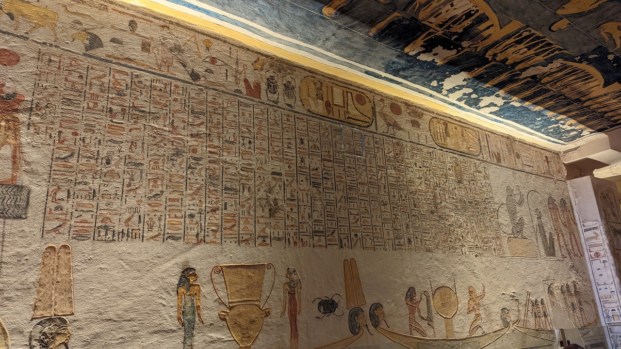 Detailed ancient wall carvings inside a burial chamber.