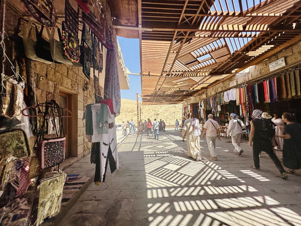 Market street with textiles and tourists.