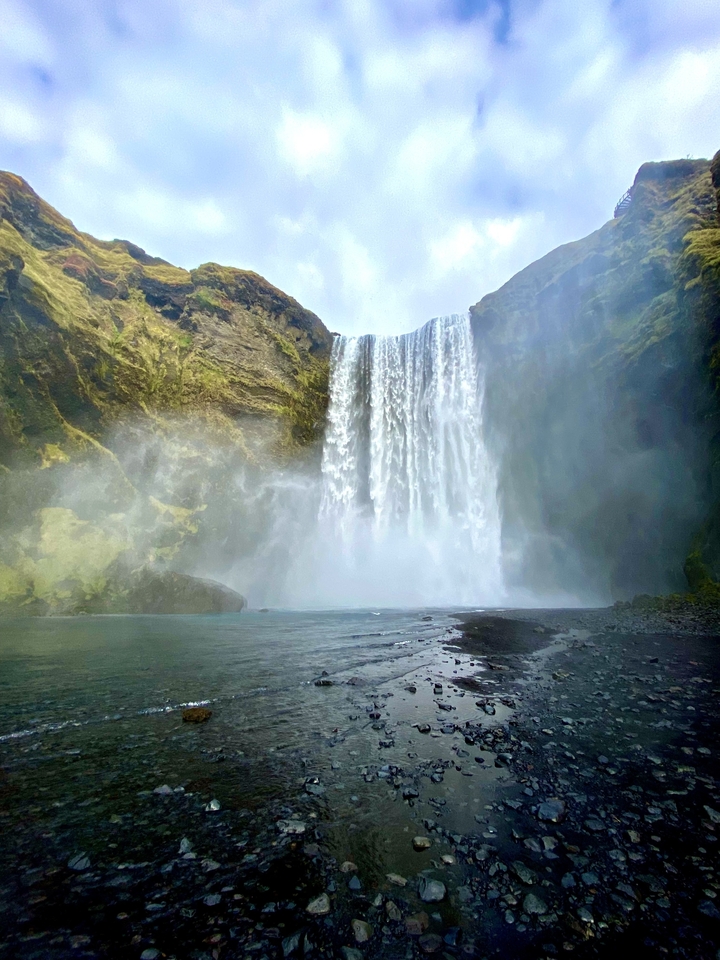 Powerful waterfall cascading down a steep cliff.