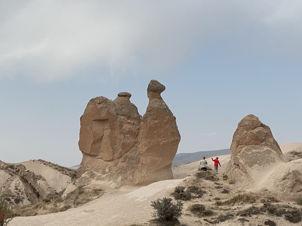 Unique rock formations with hikers in the foreground.