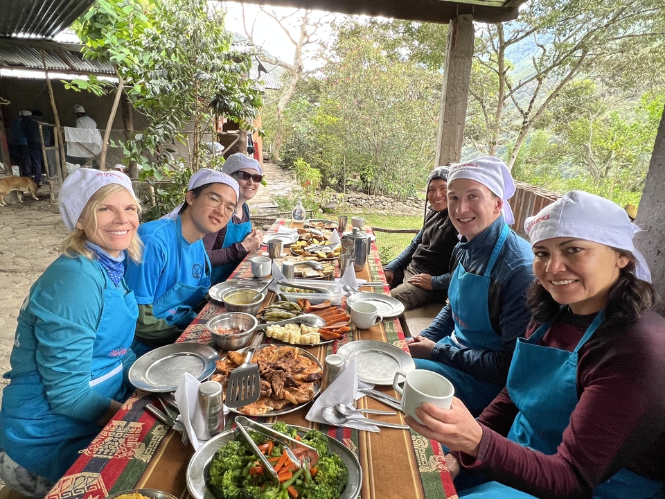 Friends dining outdoors with a buffet meal.
