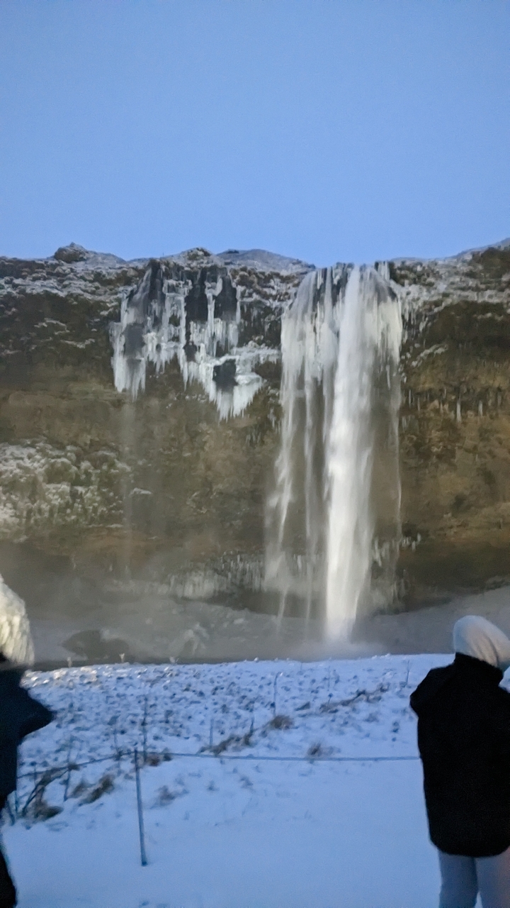 Blurred image of a waterfall, possibly icy.
