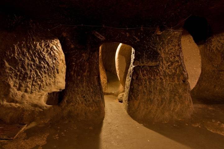 Underground rock tunnels with warm lighting.