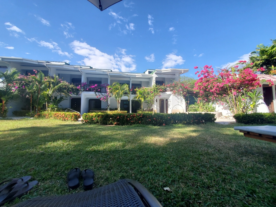 Hôtel avec des fleurs colorées et de la verdure dans le jardin.
