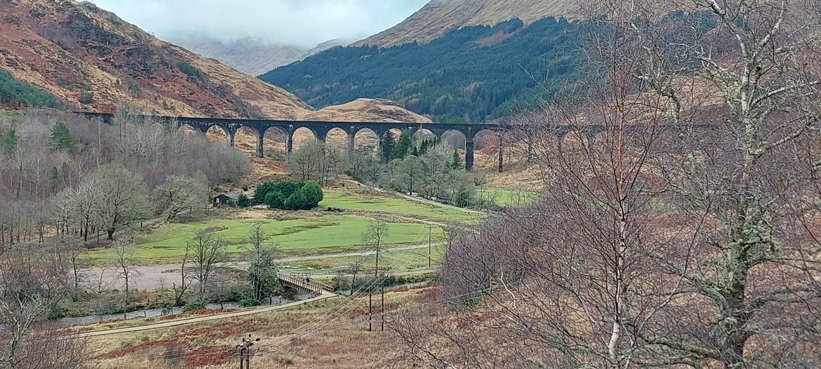 Scenic landscape with a viaduct crossing a valley.