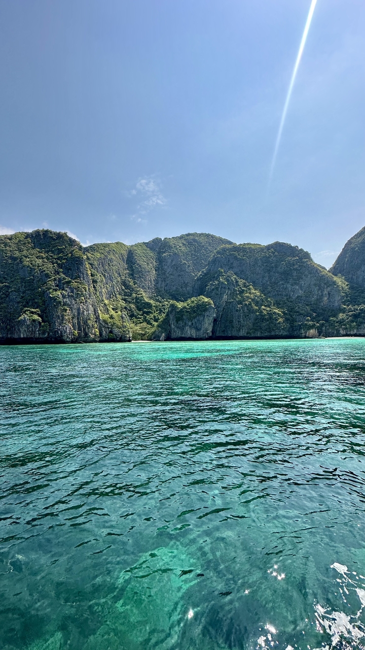 Scenic view of turquoise waters with steep cliffs.
