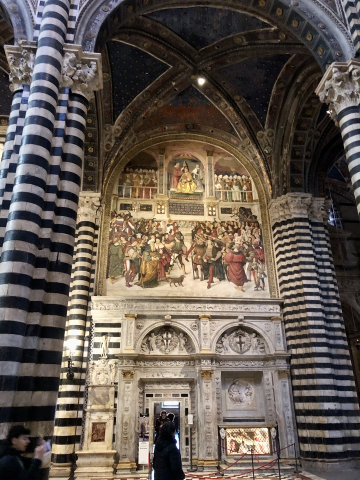 Fresques et arches à l'intérieur d'un bâtiment historique.