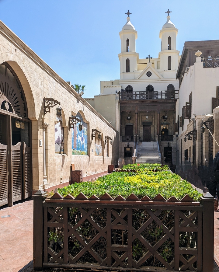 Courtyard with gardens and traditional buildings.
