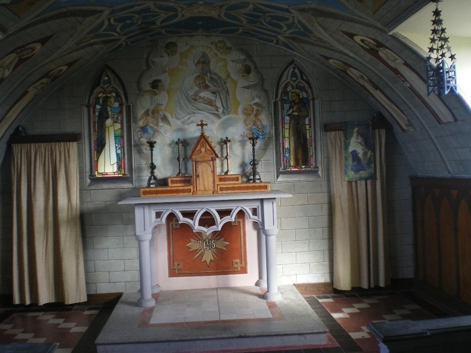 Interior view of a chapel with religious iconography.