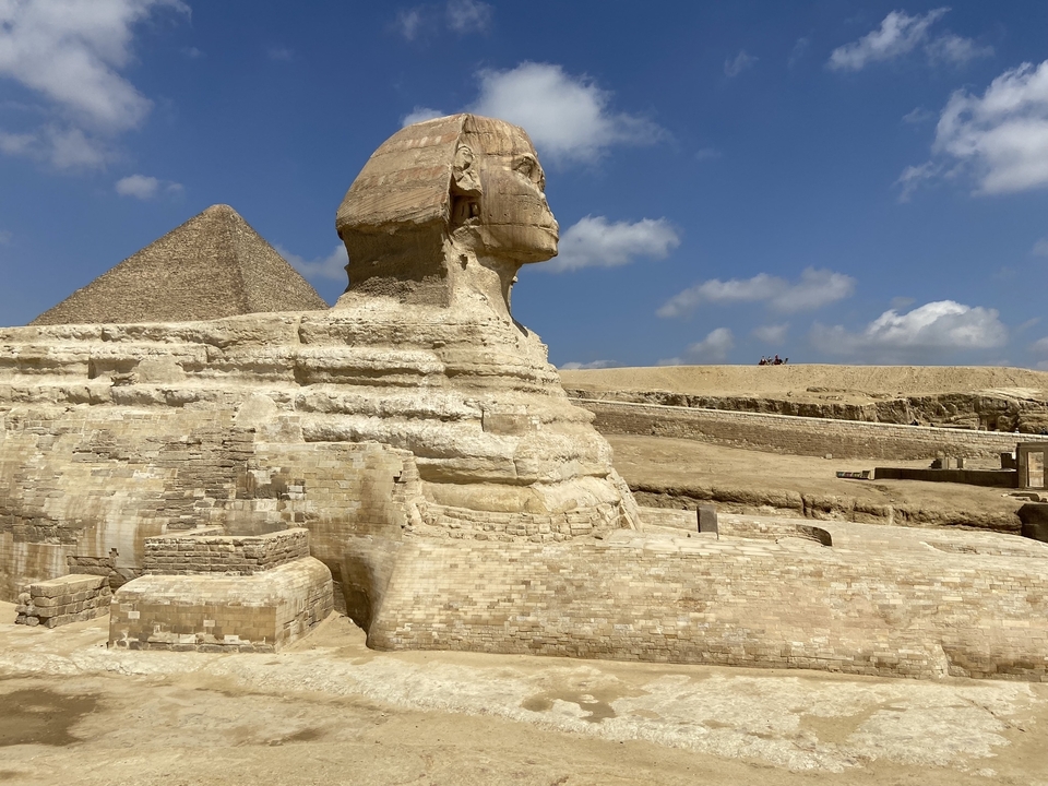 Sphinx and Pyramid at Giza under a blue sky