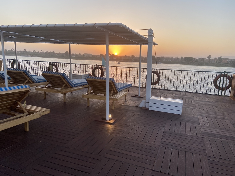 Sunset view from a deck with sun loungers