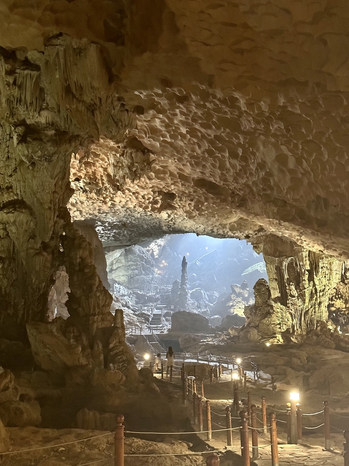 Intérieur de grotte éclairé avec stalactites.
