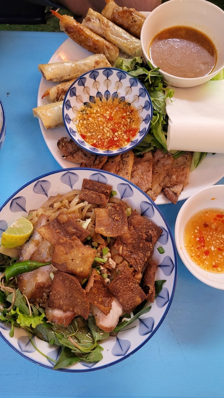 Gros plan de plats avec des nouilles, de la viande et des sauces.