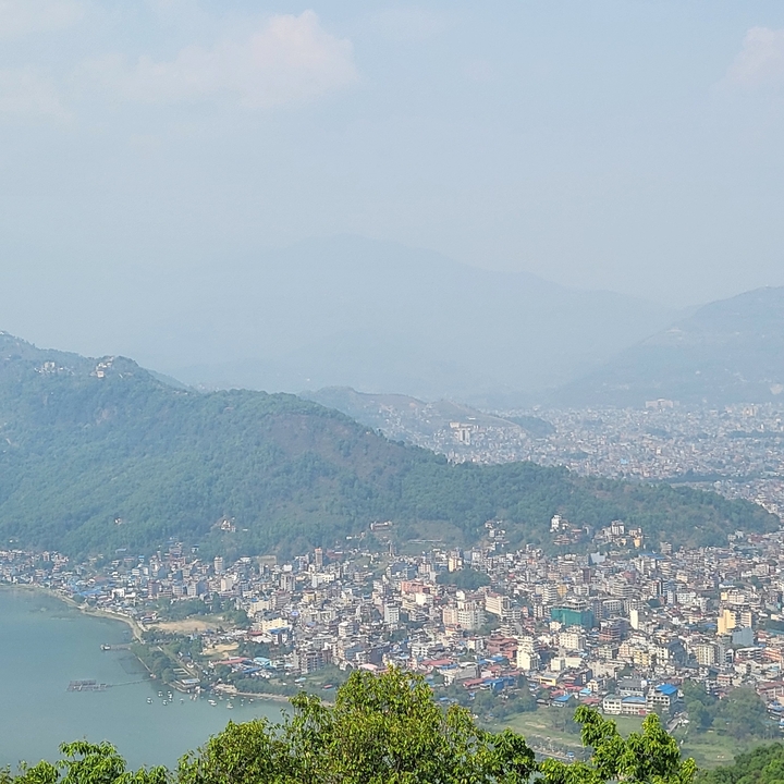 Distant view of a city with a mountain backdrop.