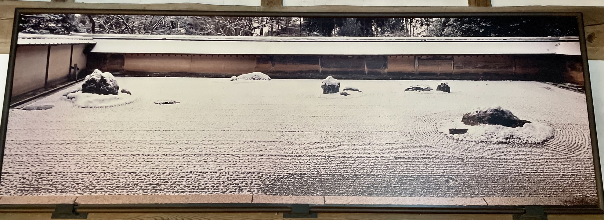 Jardin de rocaille avec des roches et du sable méticuleusement arrangés.