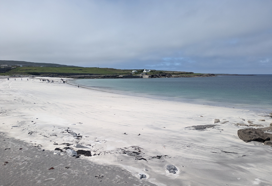 Sandy beach with clear blue waters in Ireland.