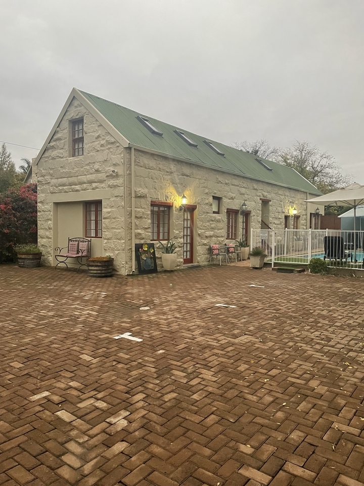 Charming stone cottage with a paved courtyard.