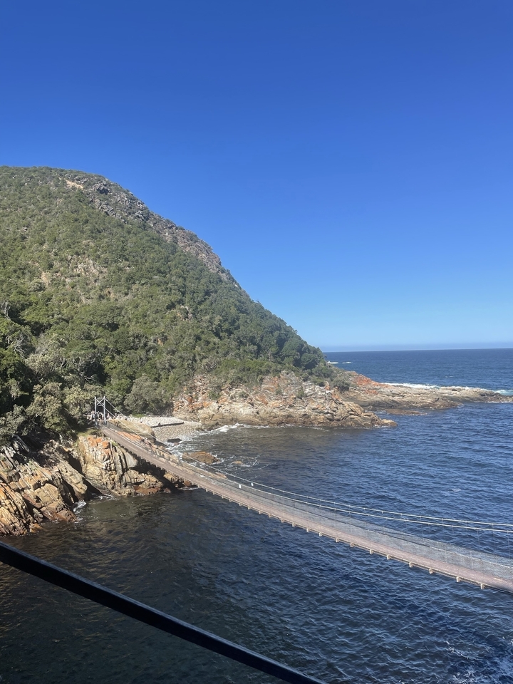 Coastal landscape with a rocky headland and ocean.