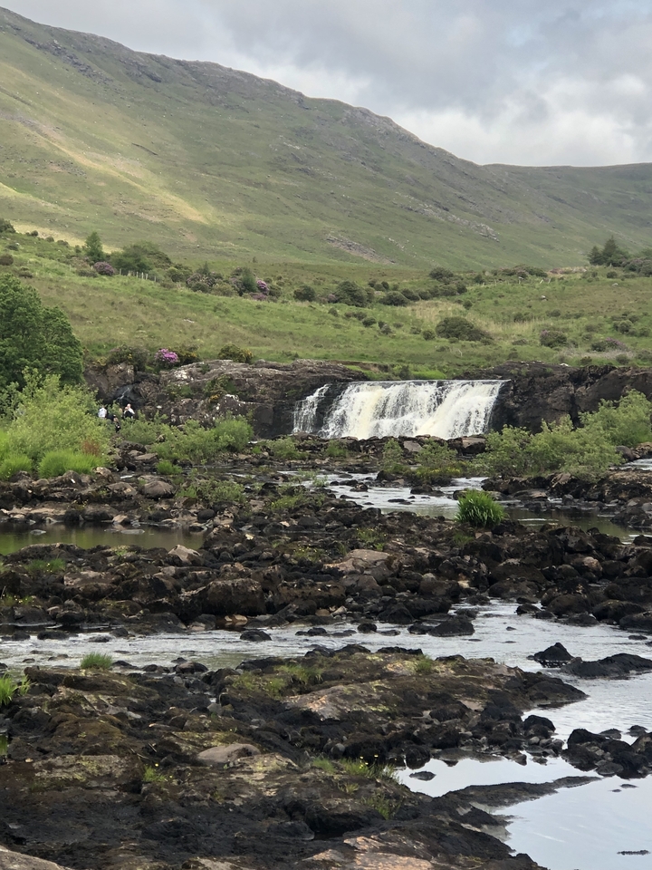 Small waterfall in a rocky, rural landscape
