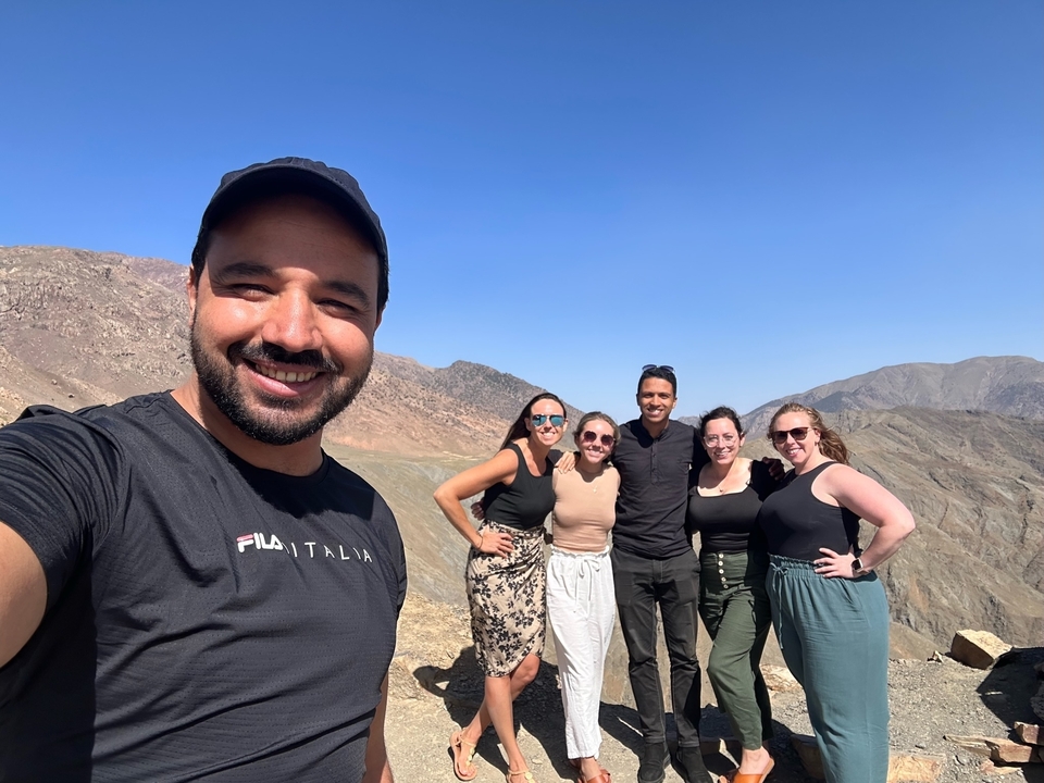 Group of friends posing in a mountainous landscape.