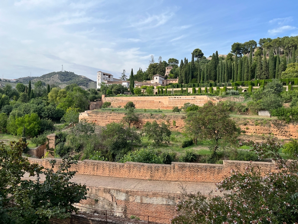 Lush green terraces with shrubs and trees.
