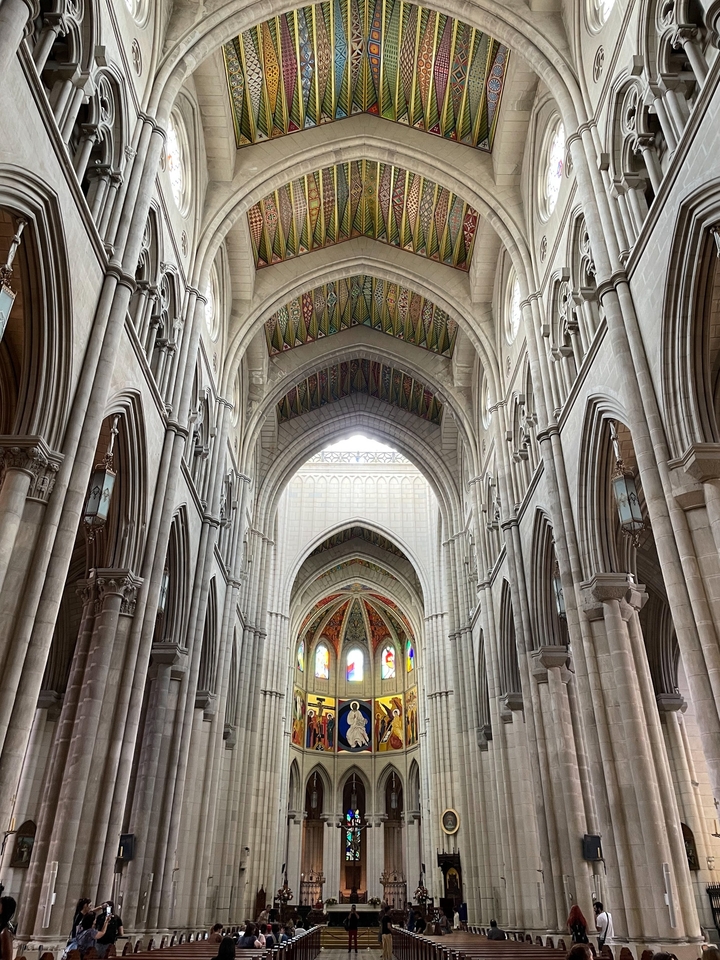 Interior of a large cathedral with stained glass windows.