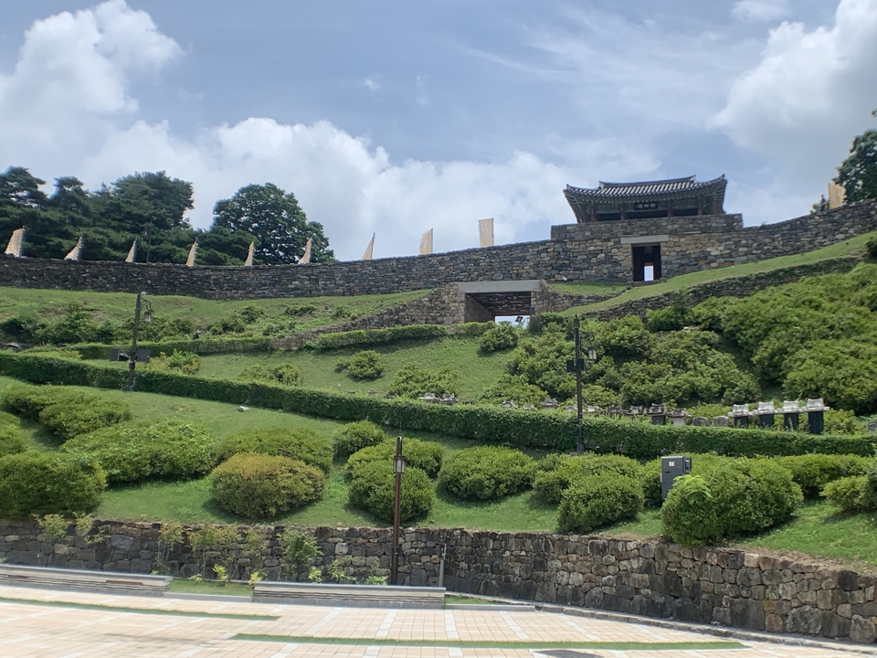 Forteresse historique avec jardins paysagers verdoyants.