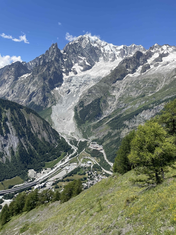 Une vue de haute montagne avec des glaciers et une vallée en contrebas.