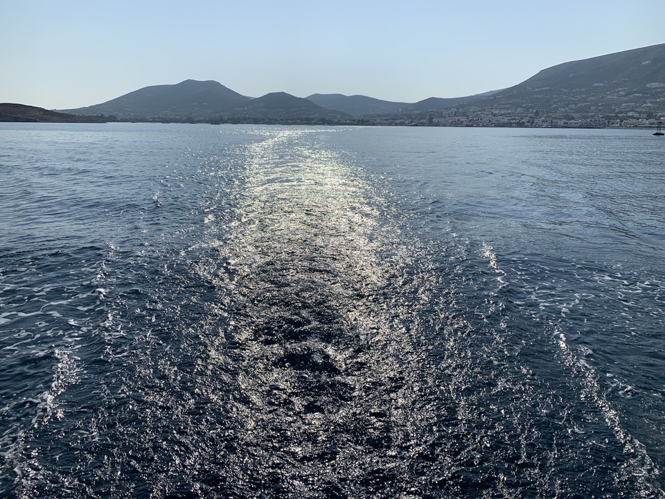 Wake pattern in water from a moving boat.