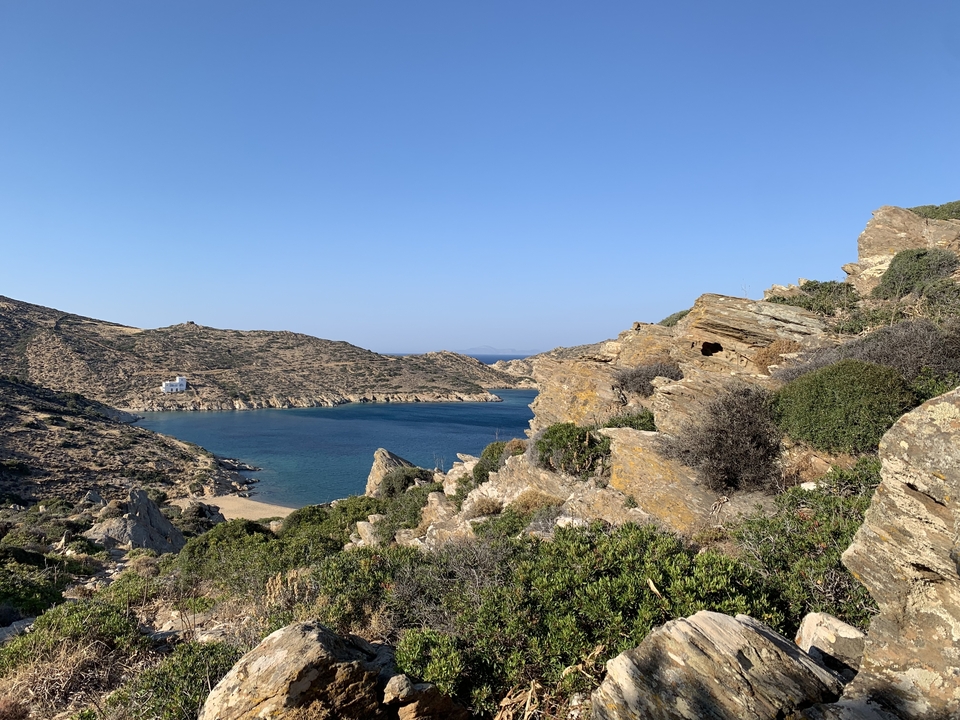 Rocky coastline with a small bay and clear skies.