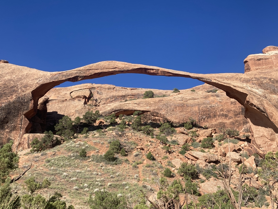 Natural rock arch in a desert environment.