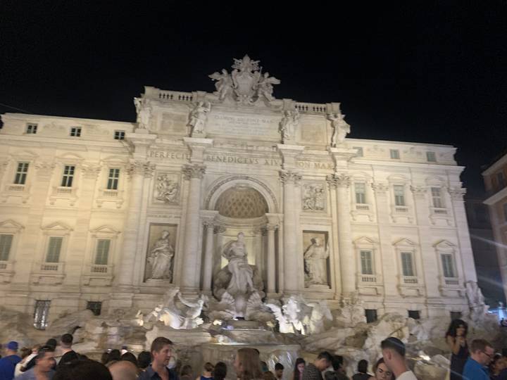 Night photo of the Trevi Fountain illuminated.