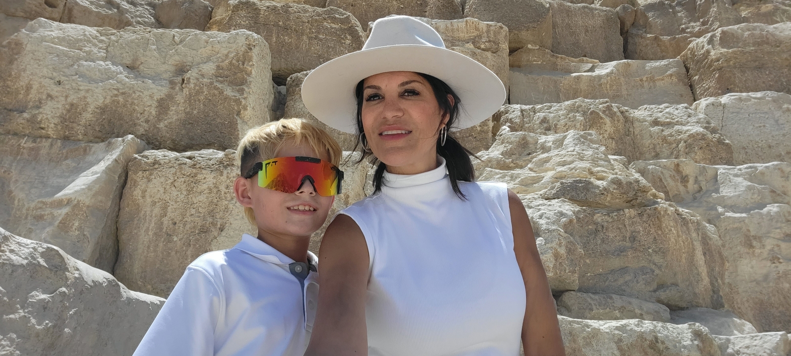 Mother and son taking a selfie in front of ancient stone structure.