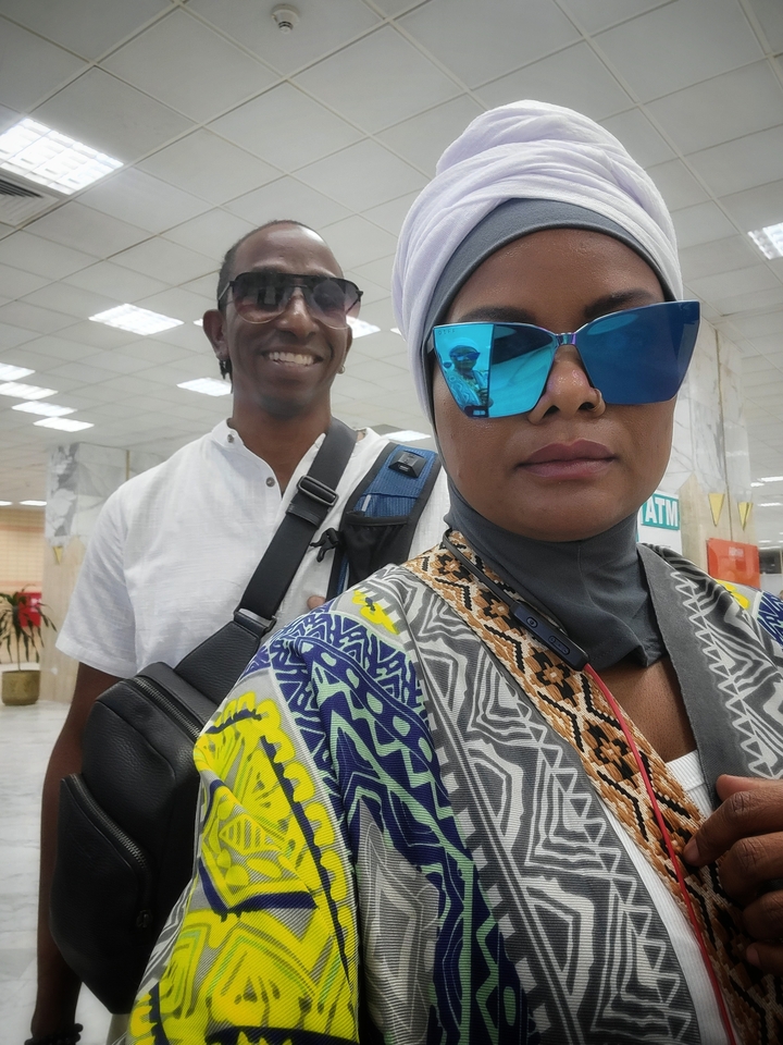 Close-up of two tourists smiling, photo has a frame effect.
