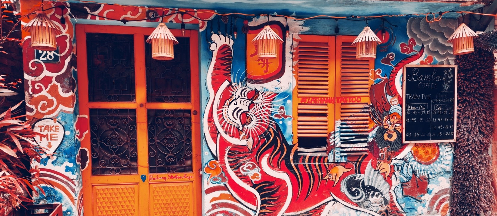 Fresque colorée sur l'extérieur d'un bâtiment avec des motifs culturels.