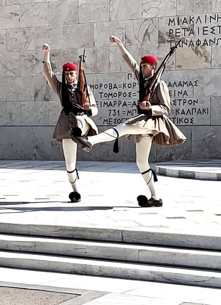 Deux gardes en tenue traditionnelle exécutant un exercice cérémoniel.