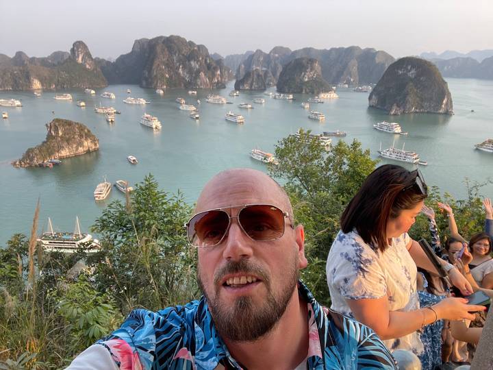 Touriste admirant la baie d'Halong avec des bateaux.
