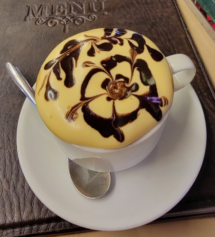Tasse de café aux œufs avec un motif complexe sur le dessus.