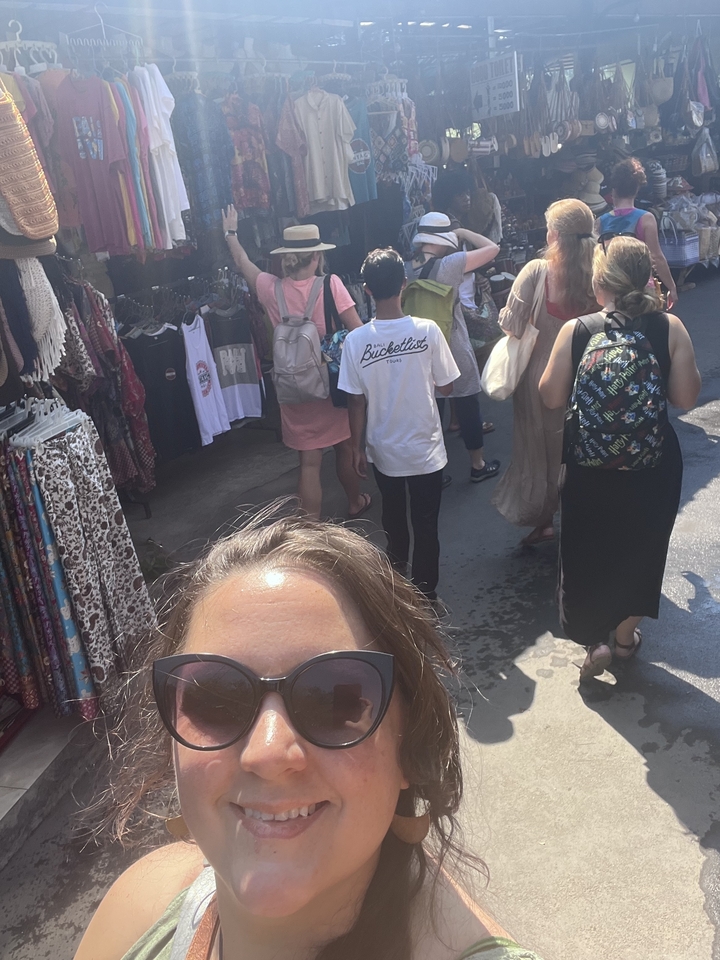 Tourists crowded at an outdoor market.