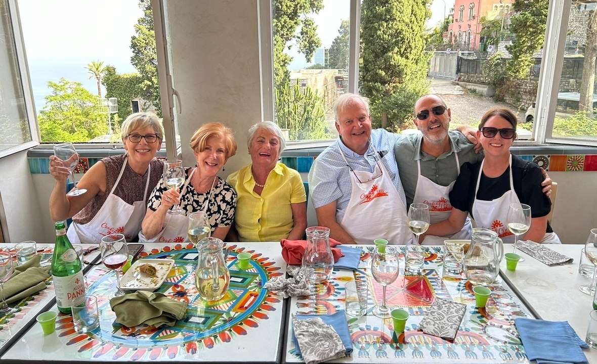 Groupe de personnes savourant un repas dans un décor italien.