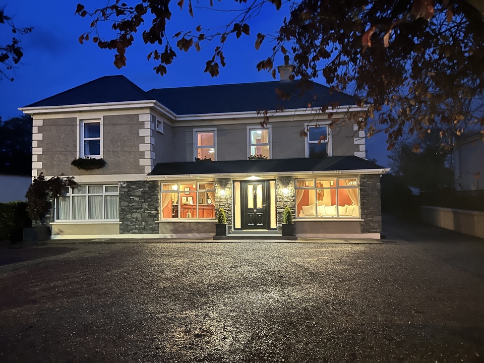 Une maison bien éclairée avec des feuilles d'automne.