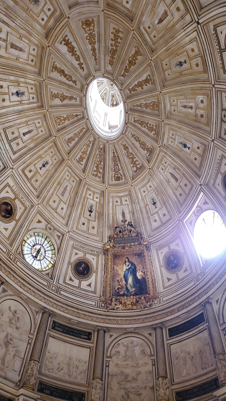 Intricately decorated dome ceiling in a church.